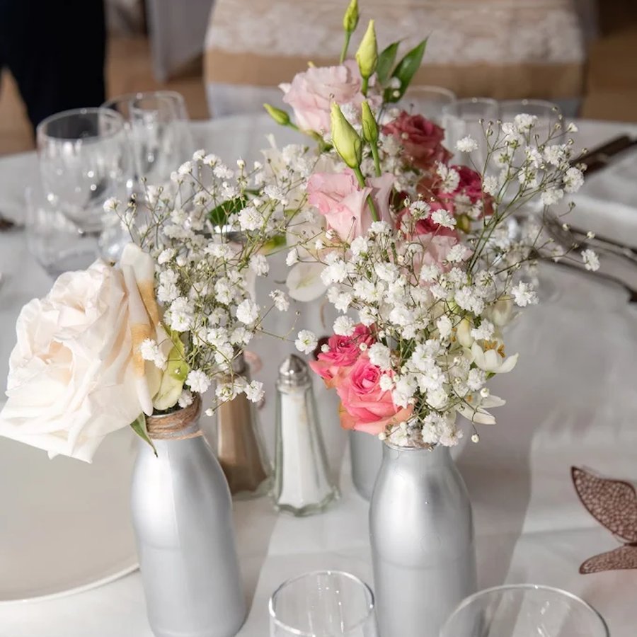 Centre de table mariage avec bouteilles argentées et gypsophile
